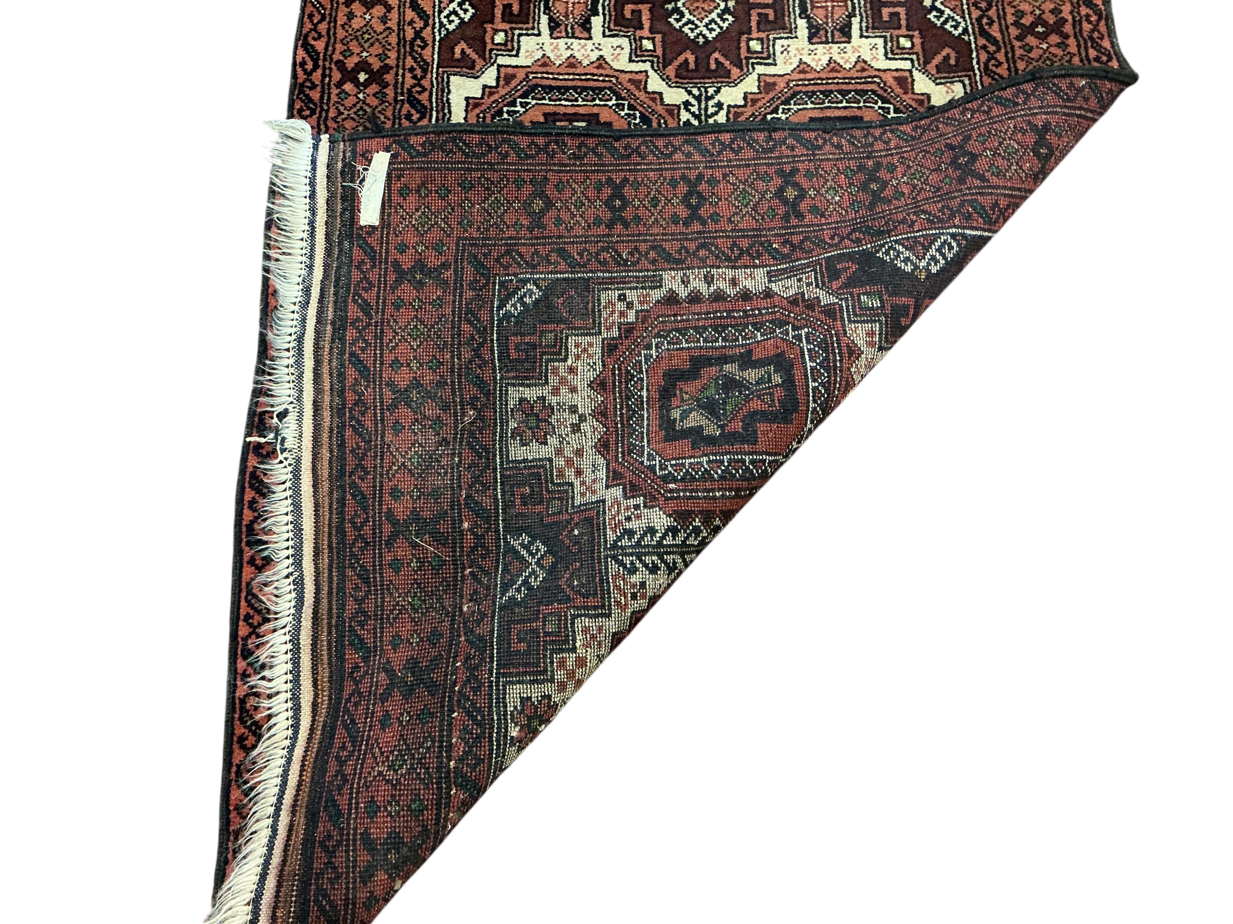 A Bokhara red ground runner and smaller rug, larger 300 x 78cm